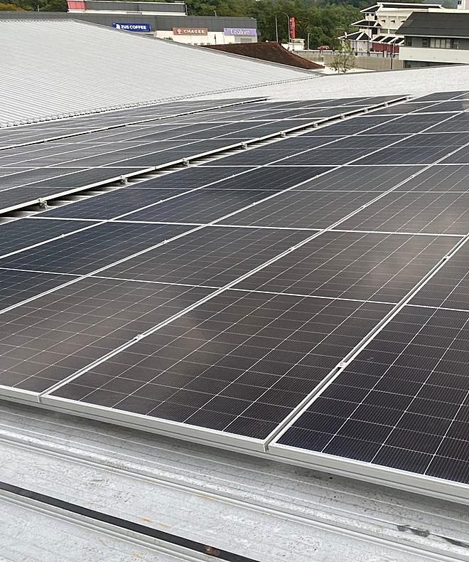 Solar panel installation crew on metal roof