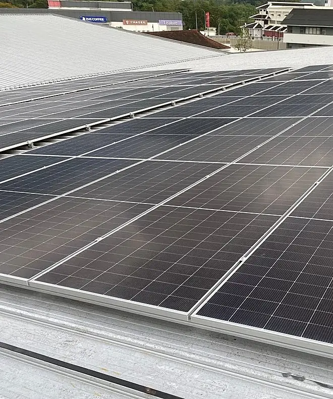 Solar panel installation crew on metal roof